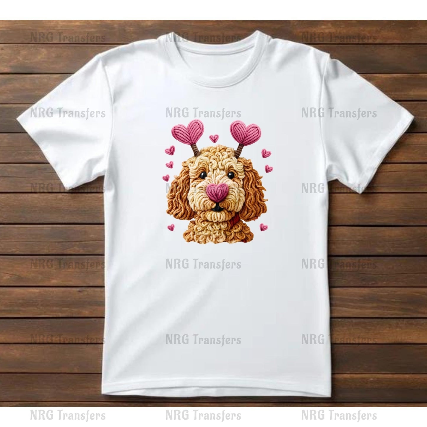 A white t-shirt with a graphic design of a dog's face wearing heart-shaped earrings and surrounded by pink hearts.