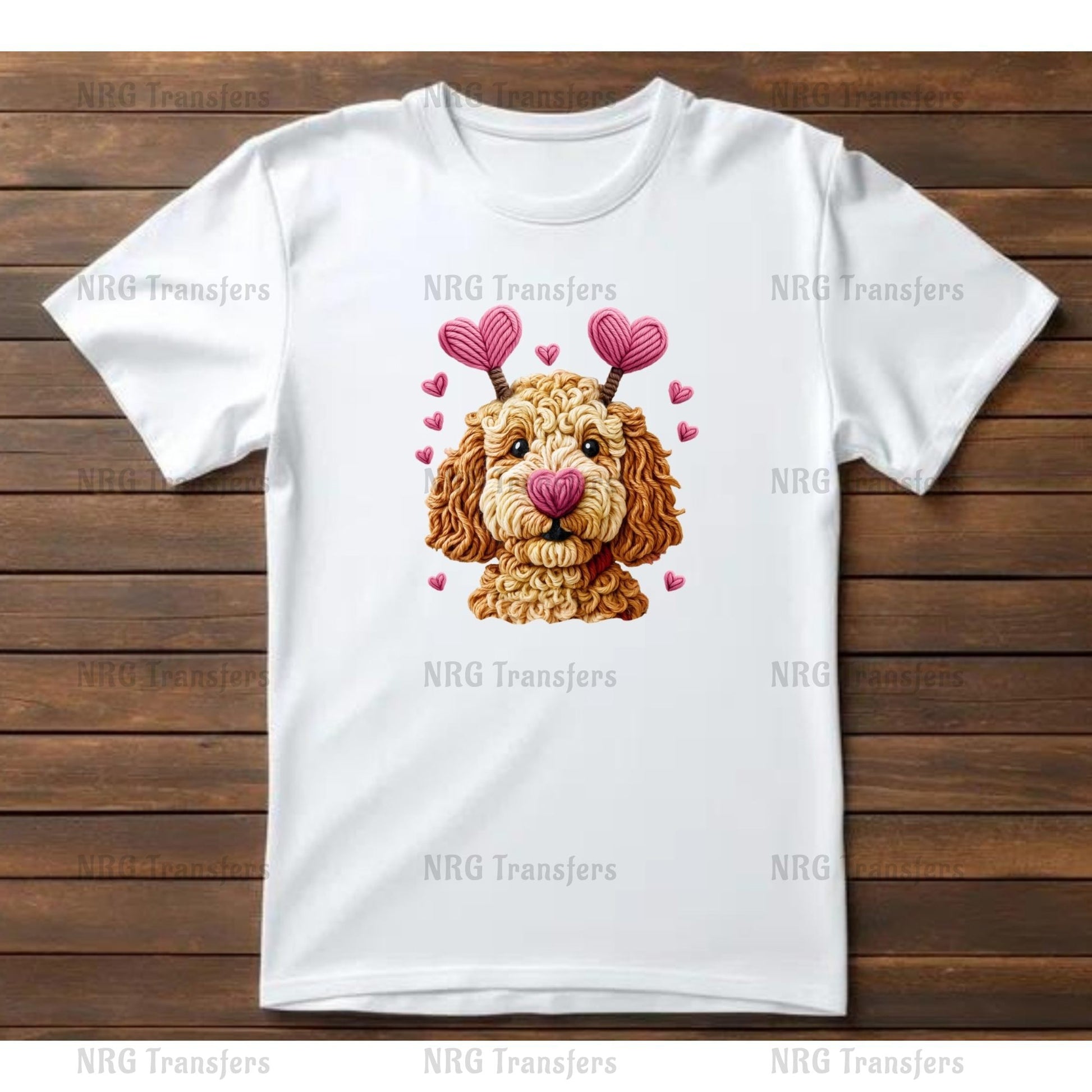 A white t-shirt with a graphic design of a dog's face wearing heart-shaped earrings and surrounded by pink hearts.