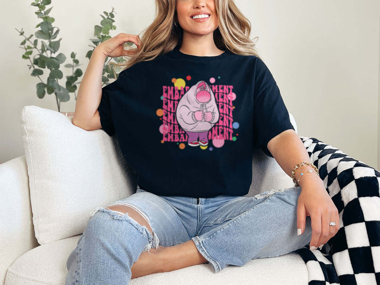 a woman sitting on a couch wearing a black shirt