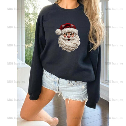 A woman wearing a black sweatshirt with a Santa Claus design on it, paired with denim shorts.
