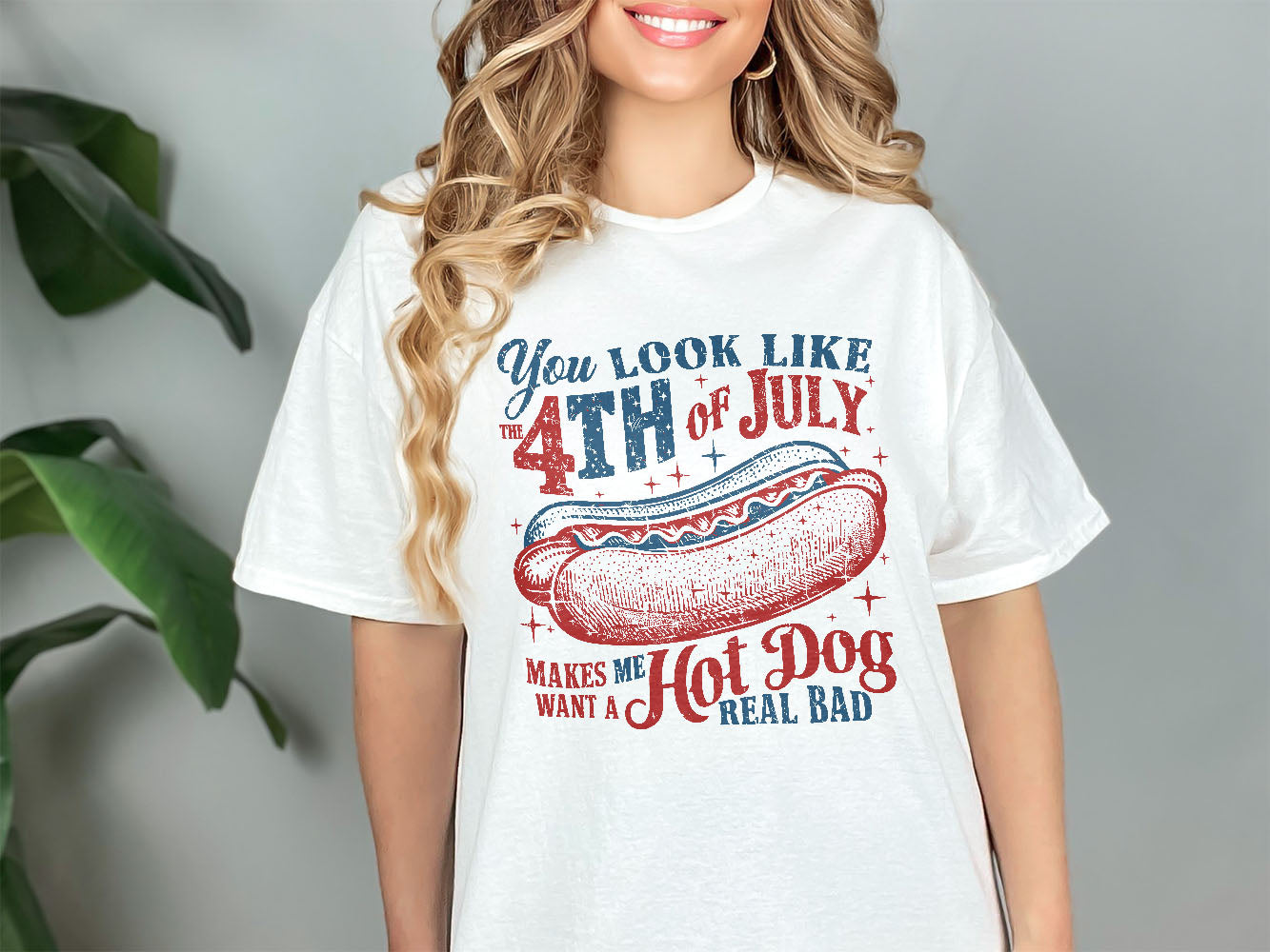 a woman wearing a white shirt with a hot dog on it