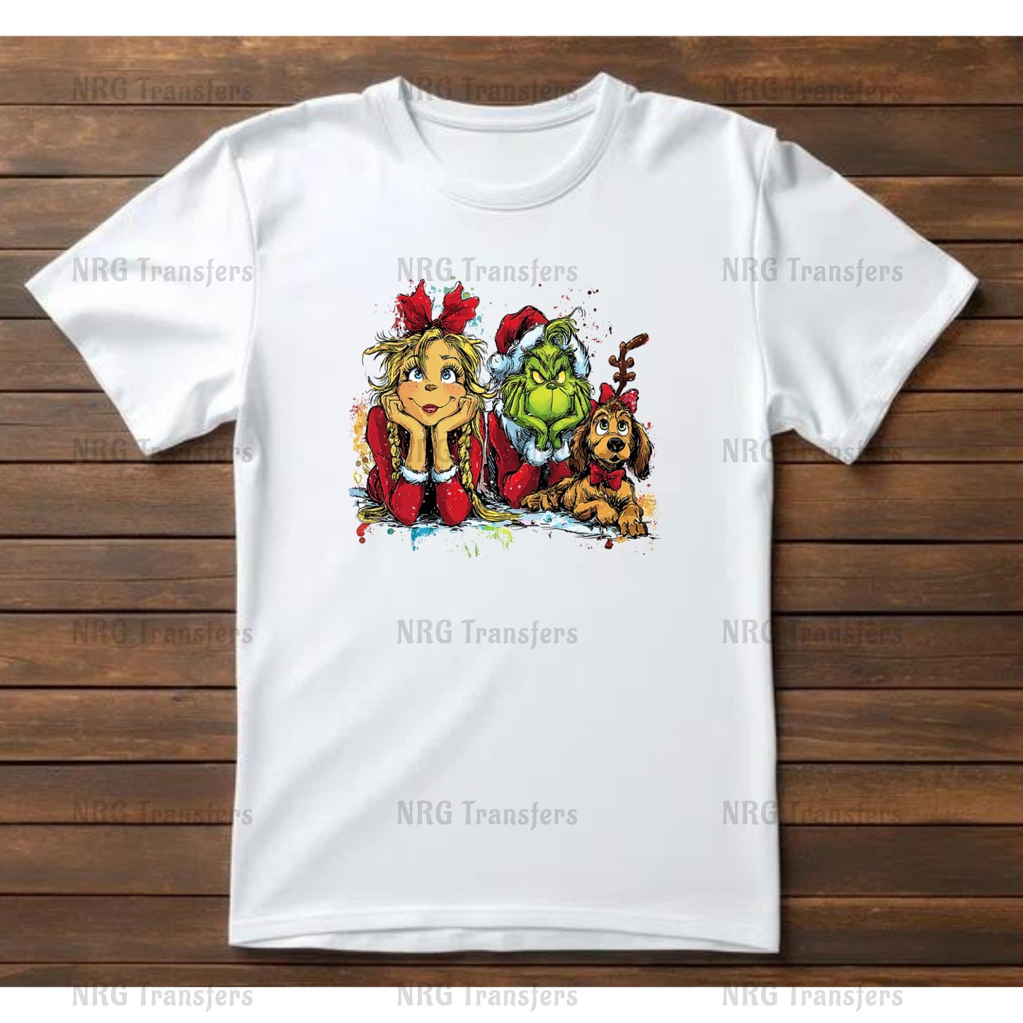 A white t-shirt with a colorful illustration of a girl, a dog, and a green monster on it, all sitting together.