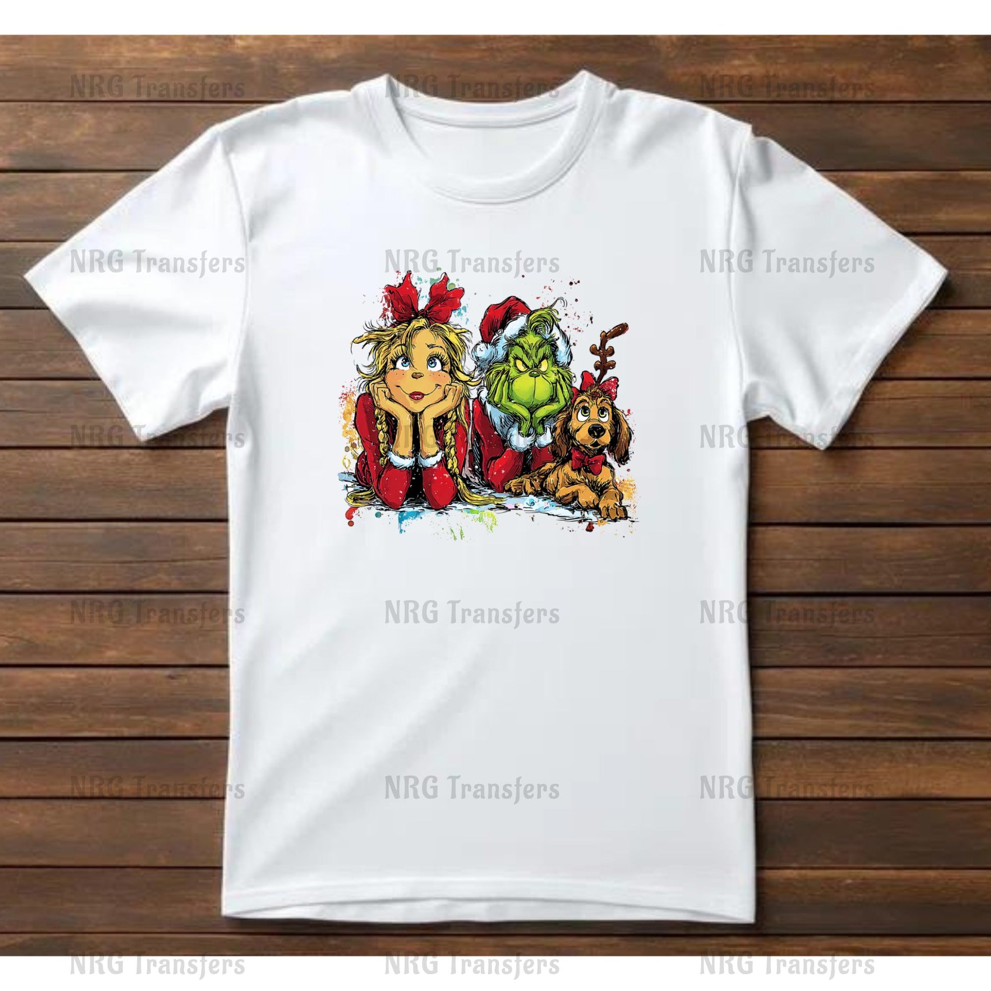 A white t-shirt with a colorful illustration of a girl, a dog, and a green monster on it, all sitting together.