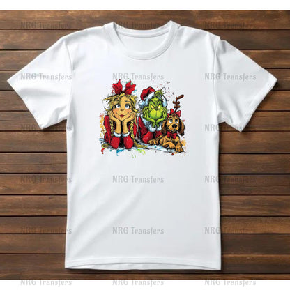 A white t-shirt with a colorful illustration of a girl, a dog, and a green monster on it, all sitting together.