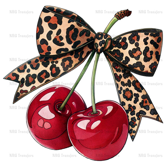 A pair of red cherries with a leopard print ribbon tied around them.