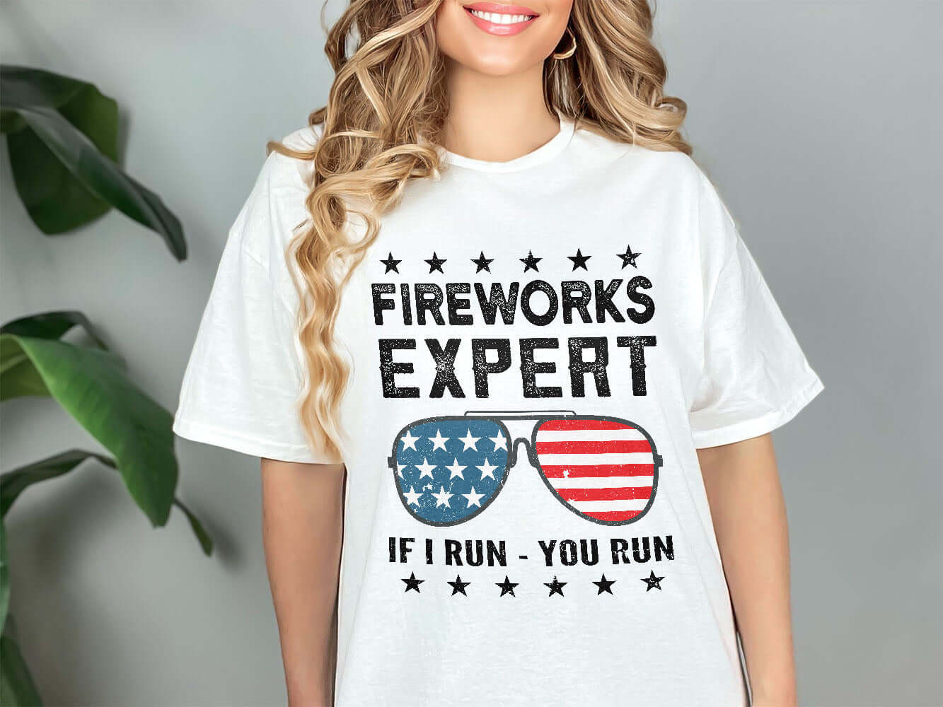 a woman wearing a t - shirt that says fireworks expert if run, you run