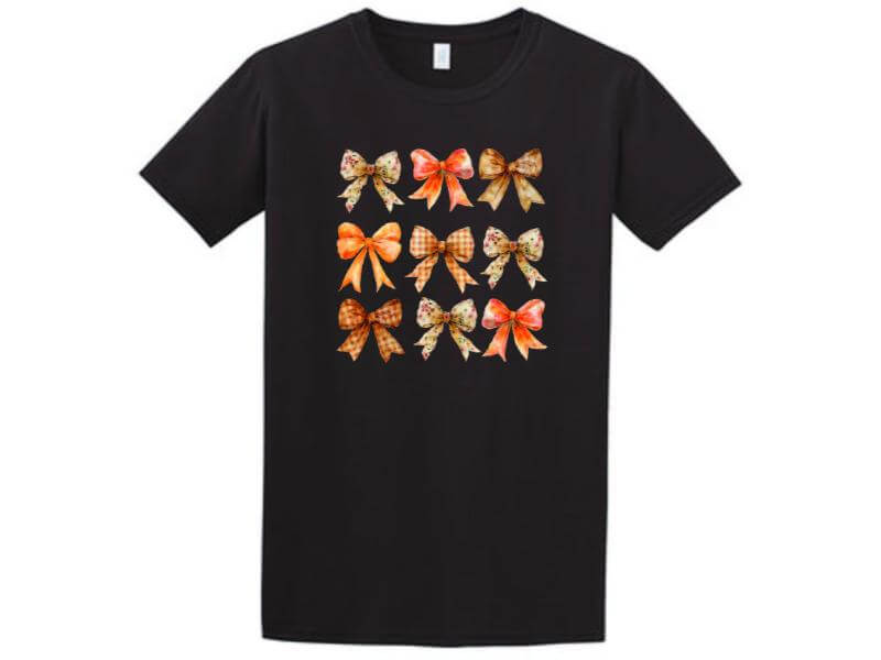 a black t - shirt with orange bows on it