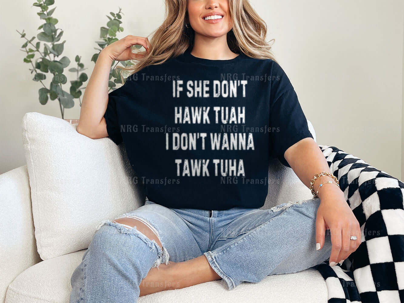 a woman sitting on a couch wearing a t - shirt that says if she don