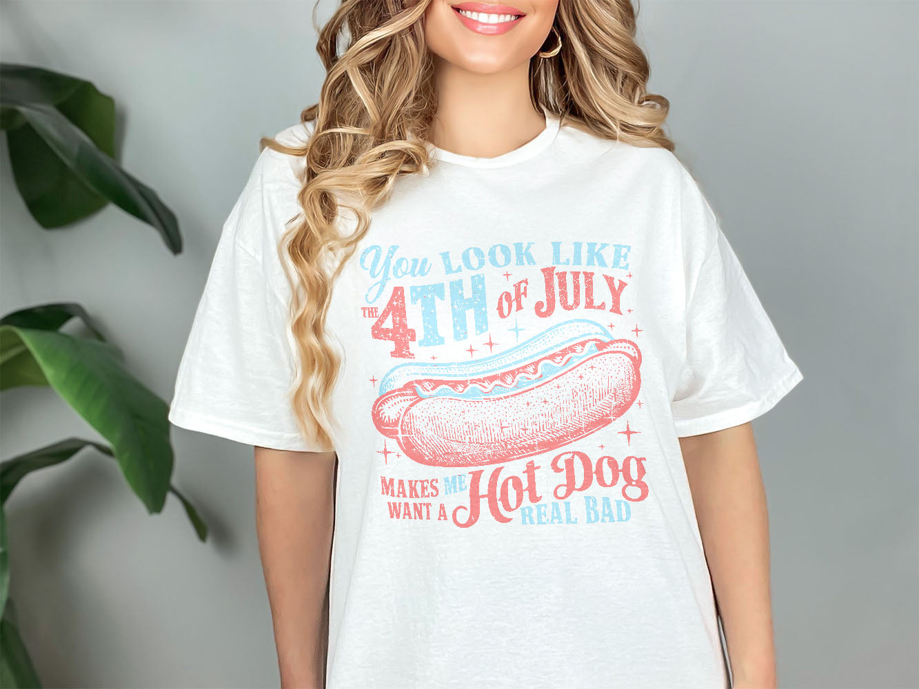 a woman wearing a white shirt with a hot dog on it