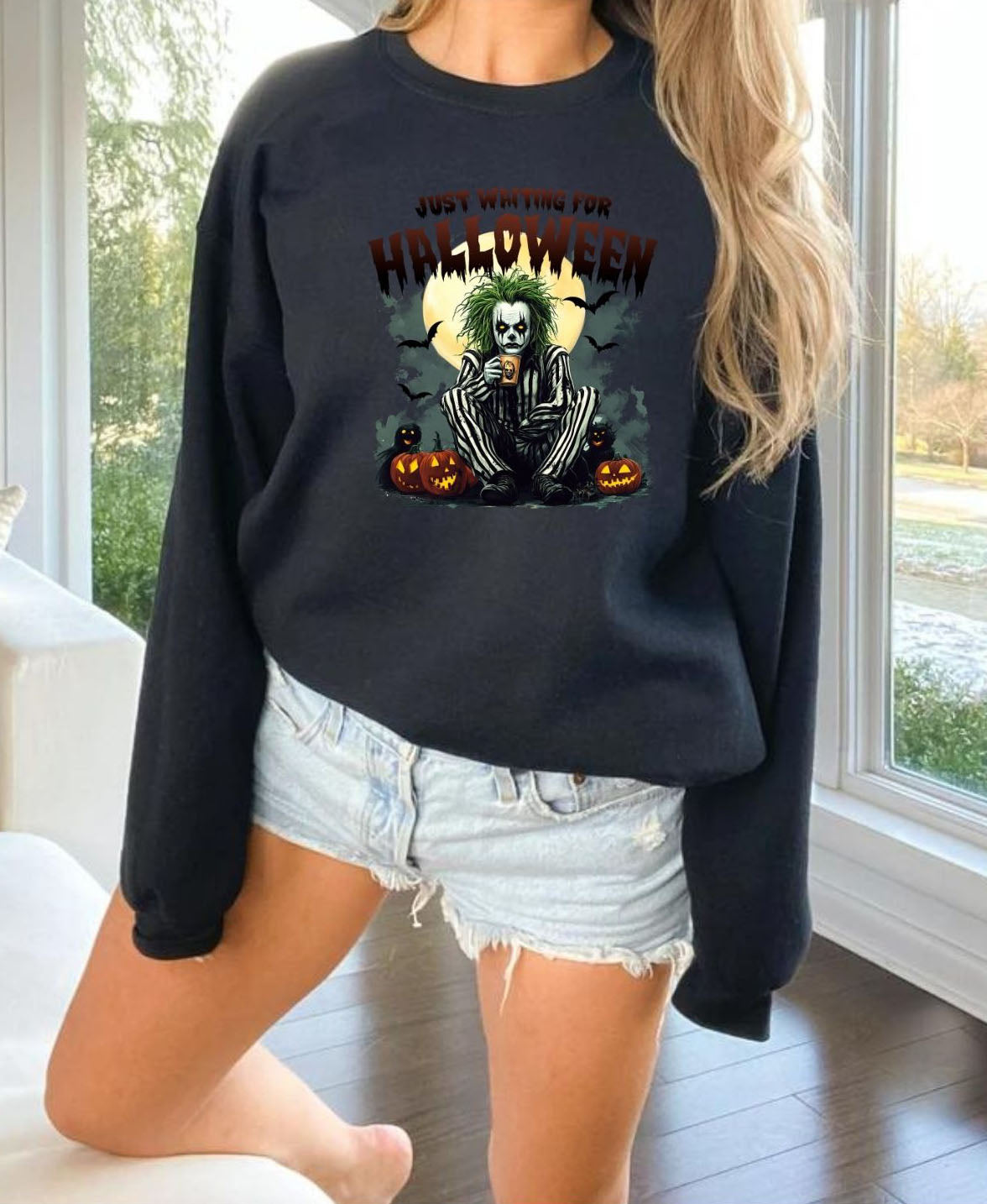 a woman wearing a black sweatshirt with a skeleton on it