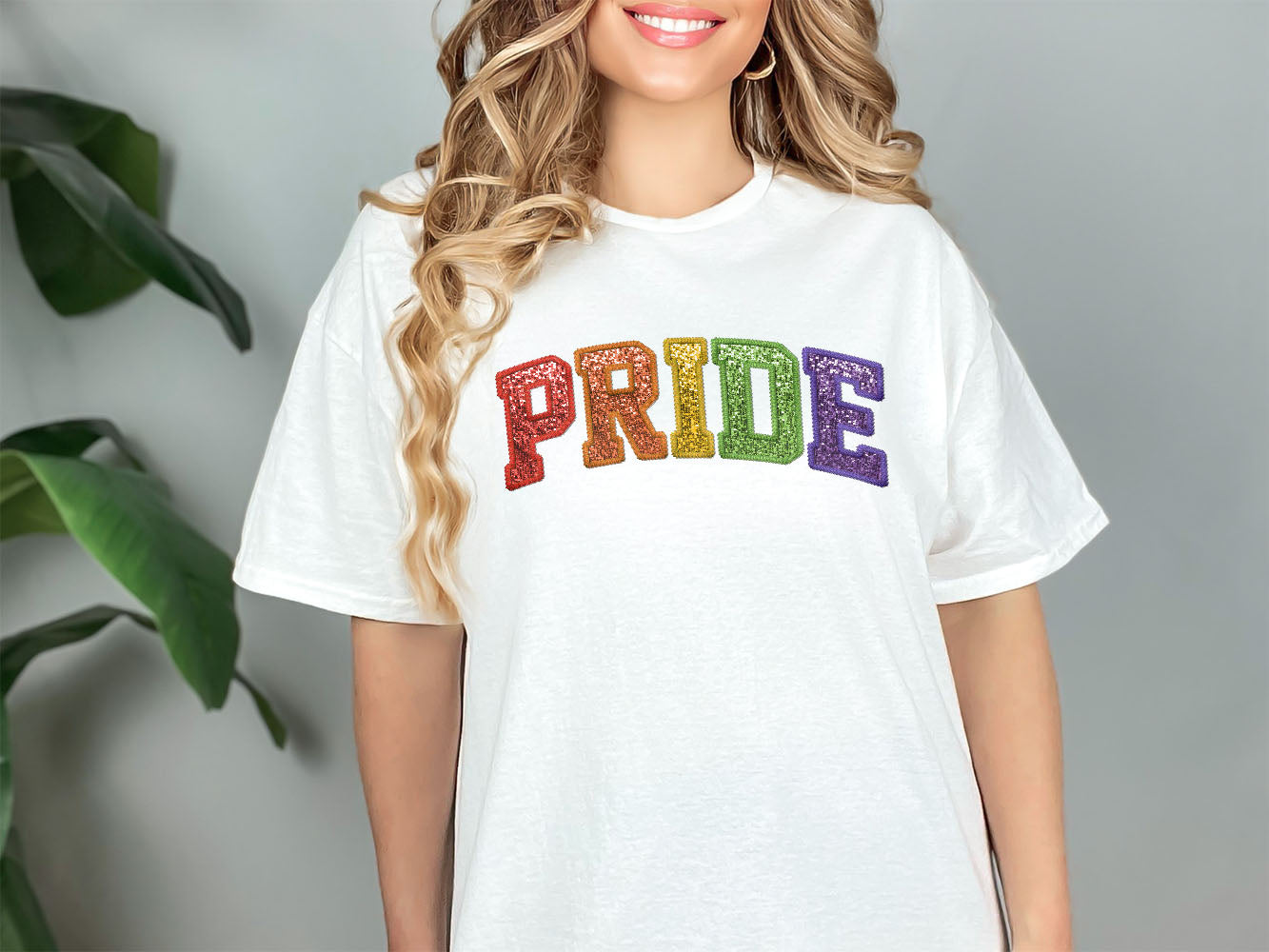 a woman wearing a white pride t - shirt