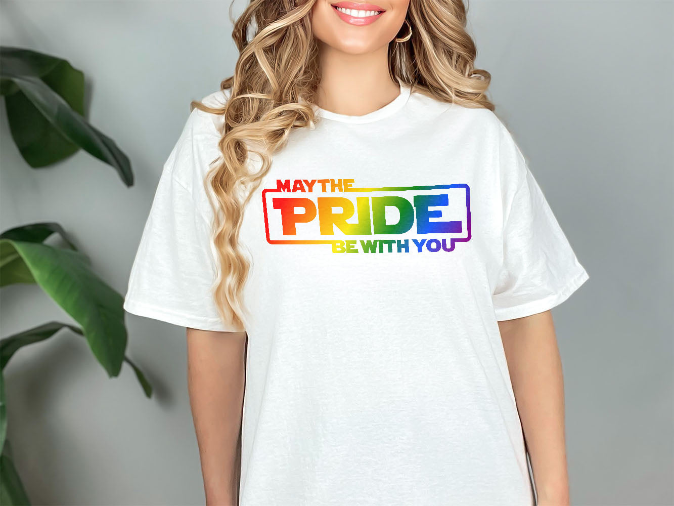 a woman wearing a white t - shirt that says may the pride be with you