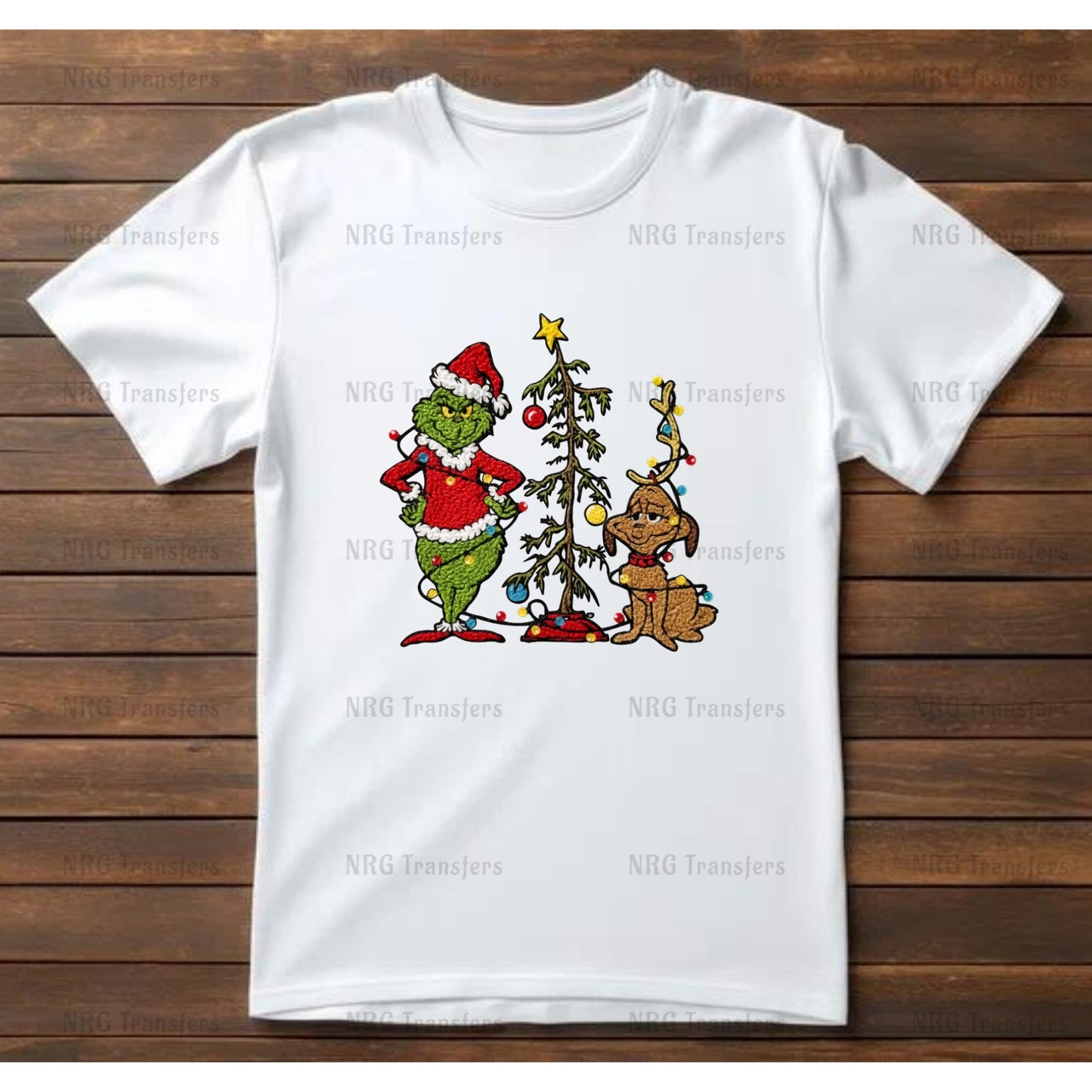 A white t-shirt with a Christmas-themed graphic design featuring the Grinch and his dog.