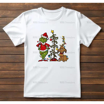 A white t-shirt with a Christmas-themed graphic design featuring the Grinch and his dog.