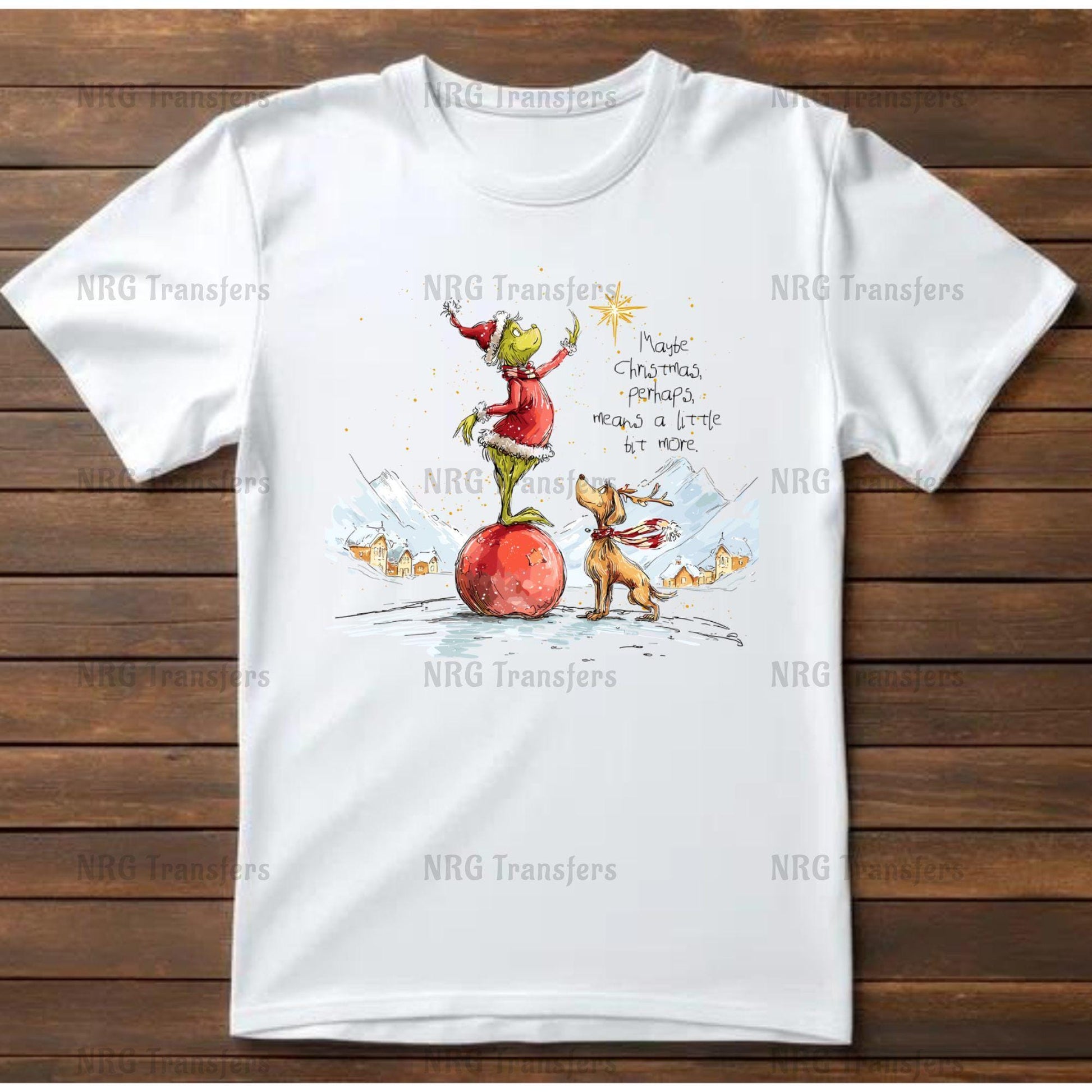 A white t-shirt with a colorful illustration depicting a frog and a dog on a snowy landscape, with a star in the sky.