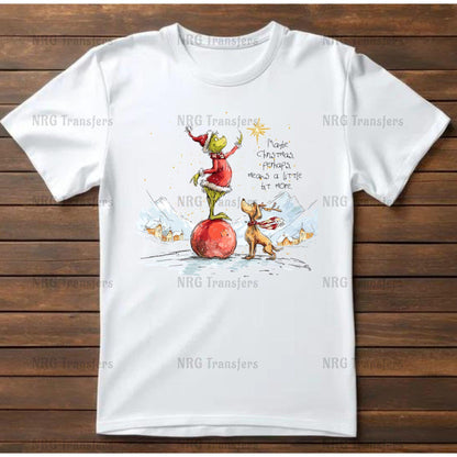 A white t-shirt with a colorful illustration depicting a frog and a dog on a snowy landscape, with a star in the sky.