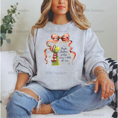 A woman wearing a gray sweatshirt with a Christmas-themed graphic and text printed on it.