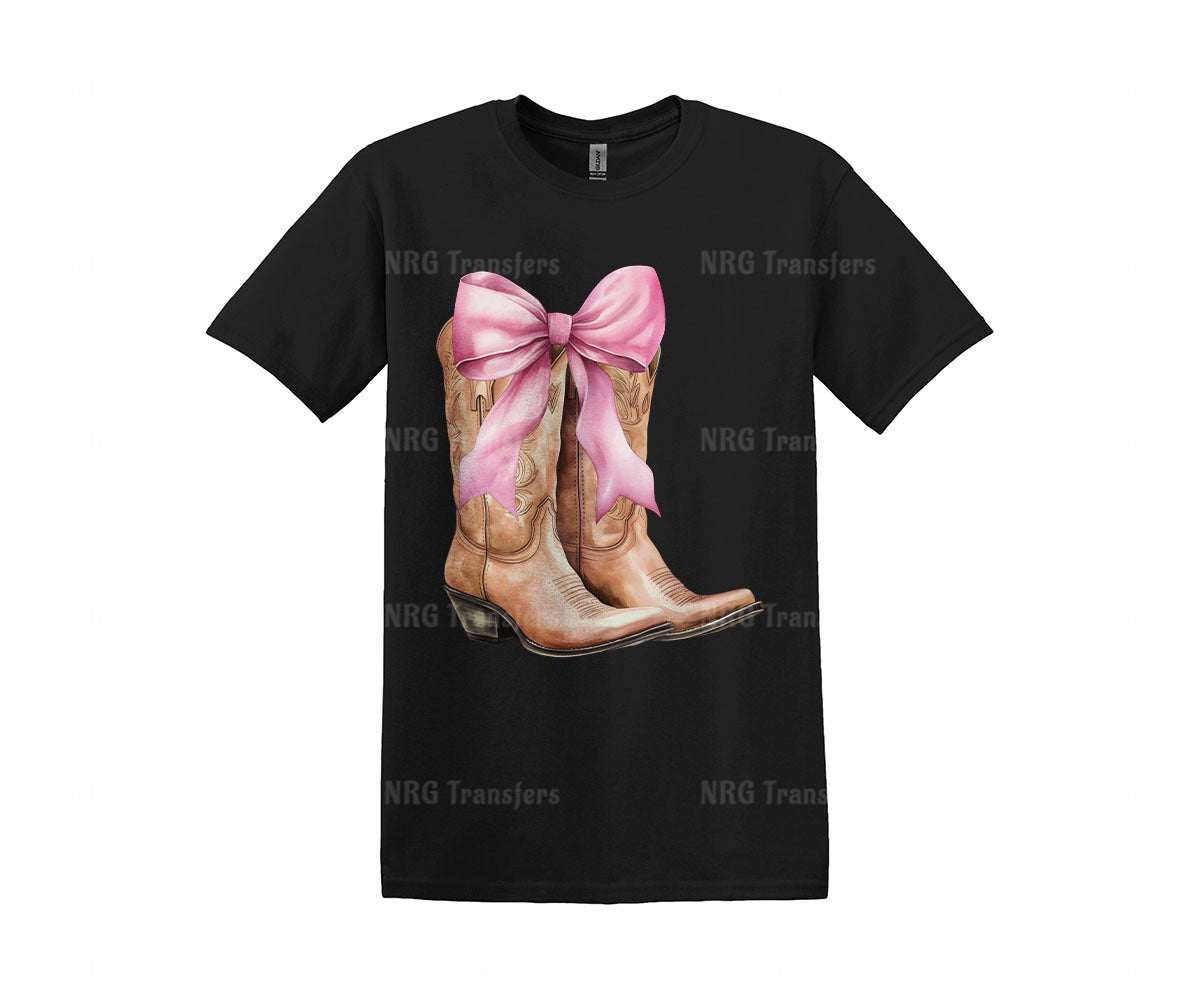 a t - shirt with a picture of a pair of cowboy boots with a pink