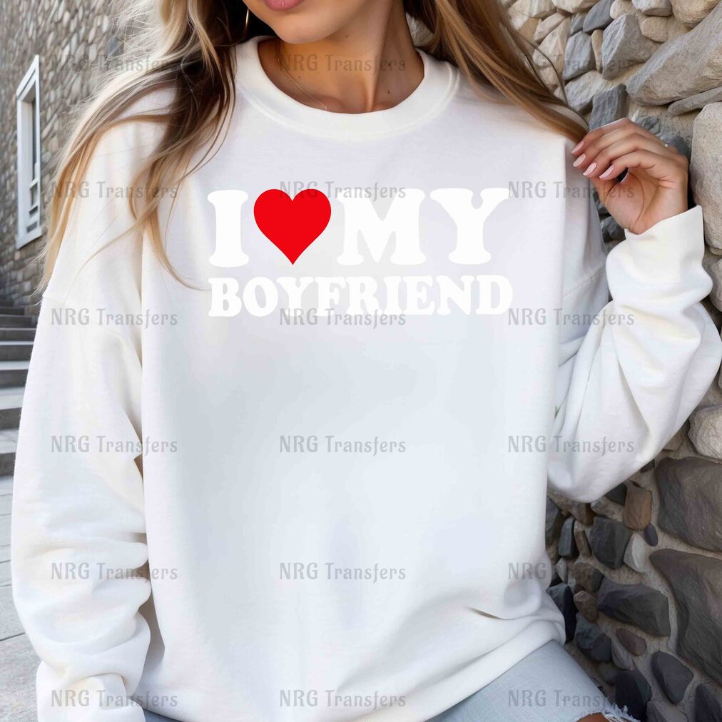 a woman wearing a sweatshirt that says i love my boyfriend