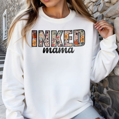 a woman wearing a white sweatshirt that says inked mama