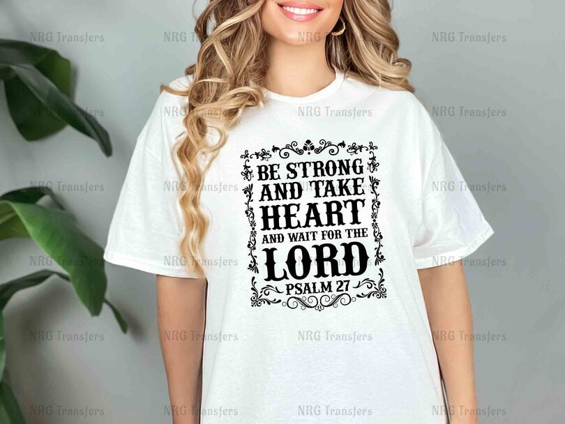 a woman wearing a white t - shirt that says be strong and take heart and