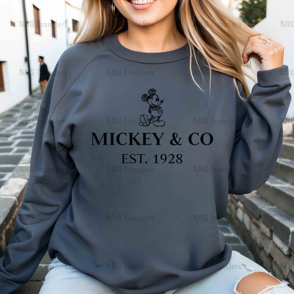 a woman wearing a mickey and co sweatshirt