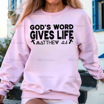 a woman wearing a pink sweatshirt that says god's word gives life