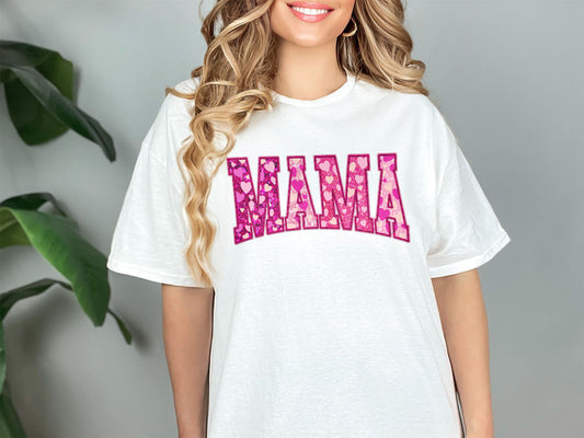 a woman wearing a white shirt with the word mama printed on it