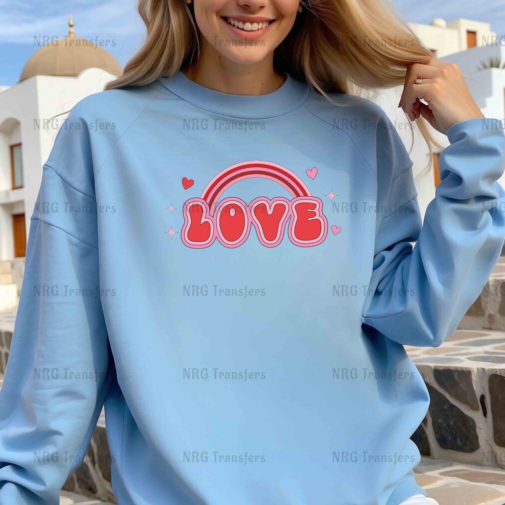 a woman wearing a blue sweatshirt with the word love on it