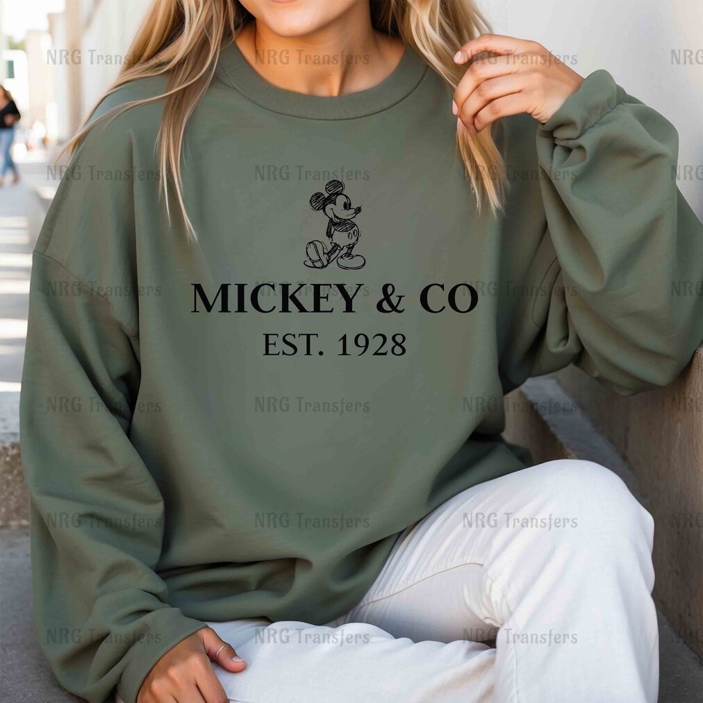 a woman wearing a mickey and co sweatshirt