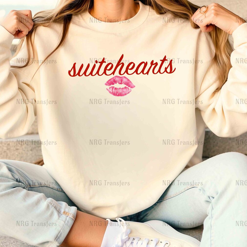 a woman sitting on a couch wearing a sweatshirt that says suitebears