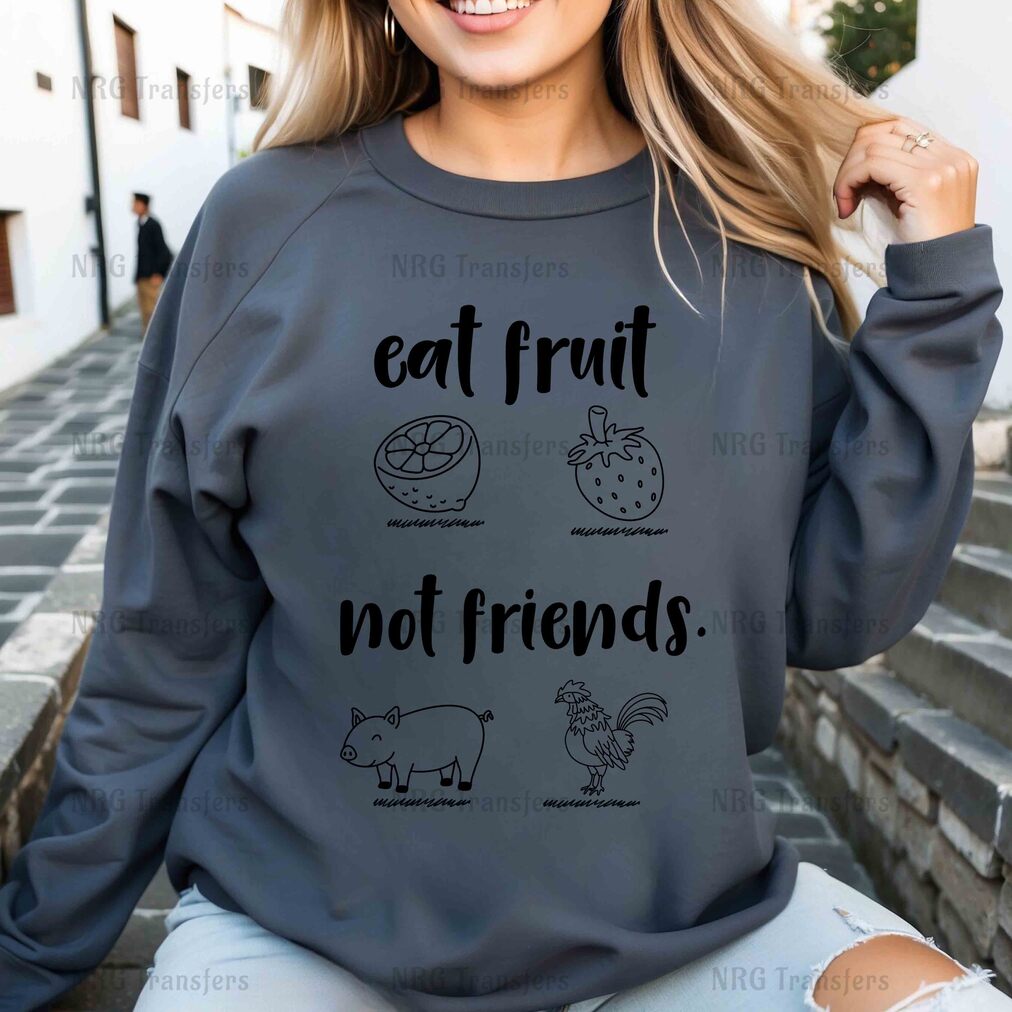 a woman wearing a sweatshirt that says eat fruit not friends