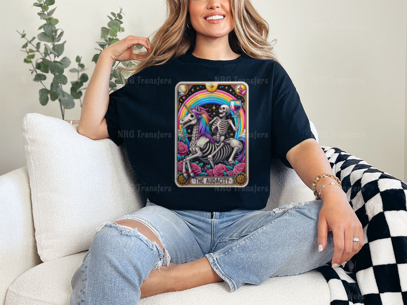 a woman sitting on a couch wearing a t - shirt with a skeleton on it