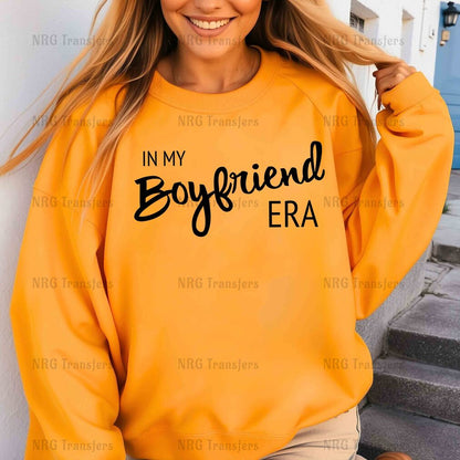 a woman wearing a sweatshirt that says in my boyfriend era