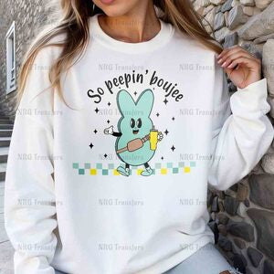 a woman wearing a white sweatshirt with a cartoon character on it