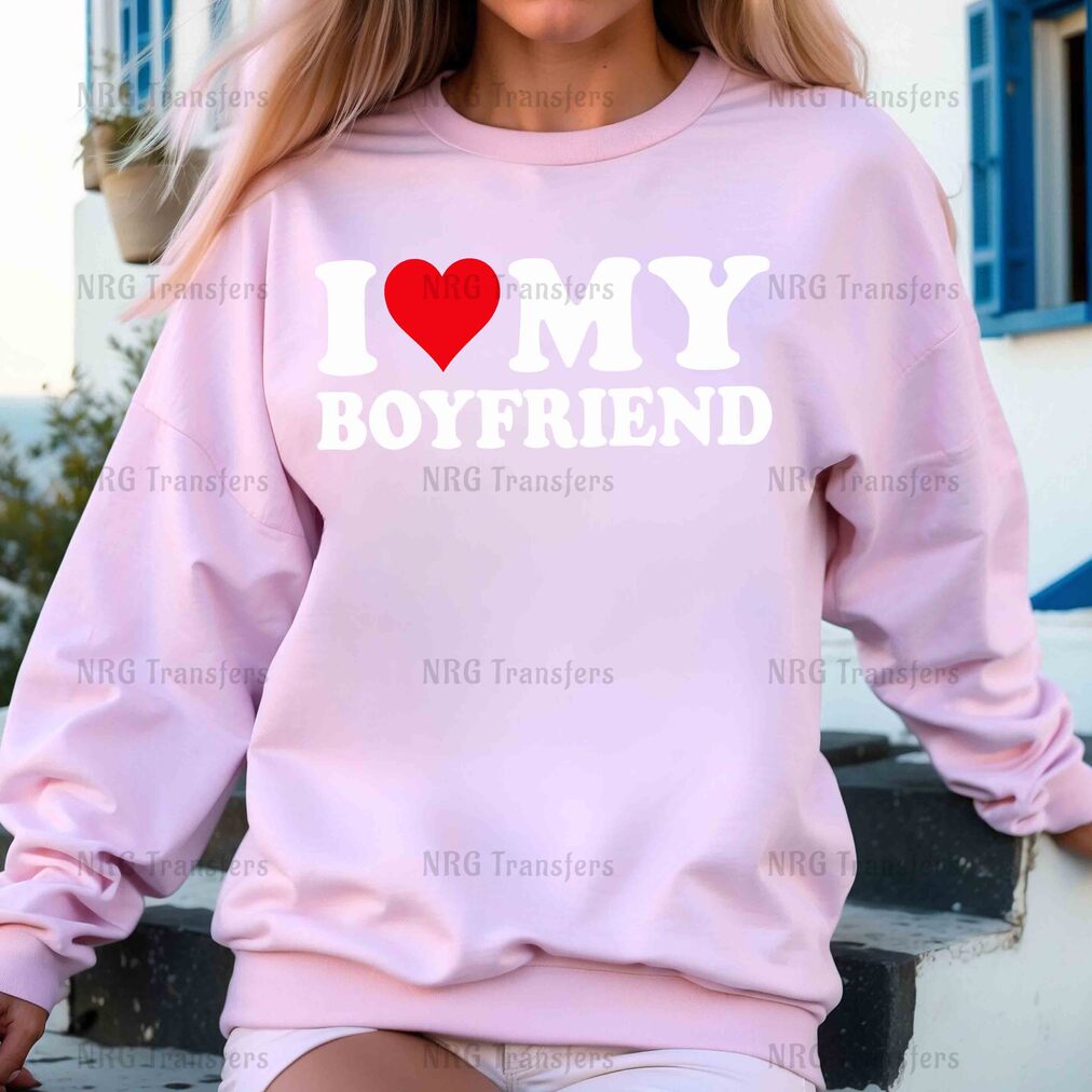 a woman wearing a pink sweatshirt that says i love my boyfriend