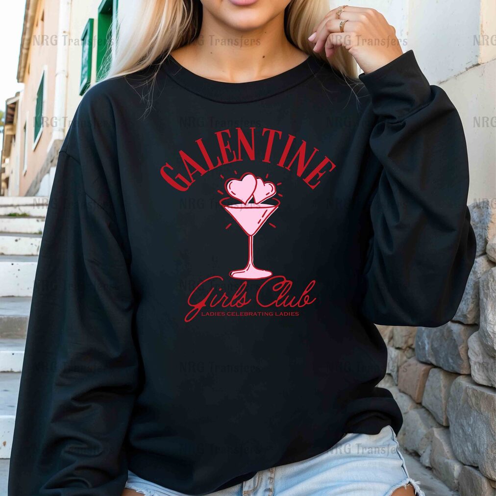 a woman wearing a black sweatshirt with a pink martini on it