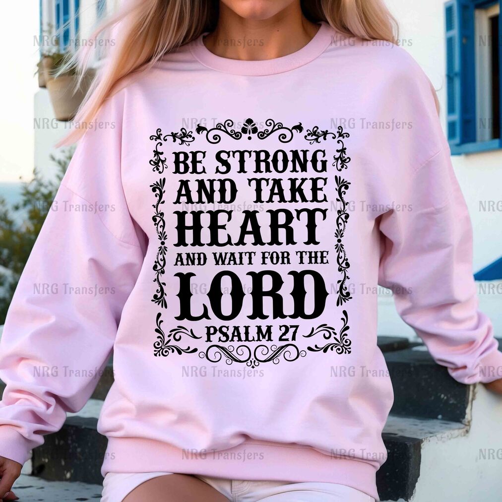 a woman wearing a pink sweatshirt that says be strong and take heart and wait for