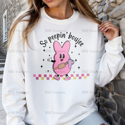 a woman wearing a white sweatshirt with a pink bunny on it