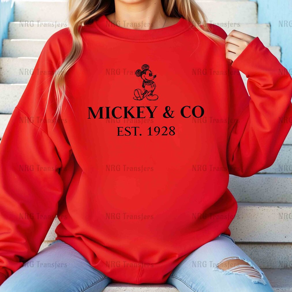 a woman wearing a mickey and co sweatshirt