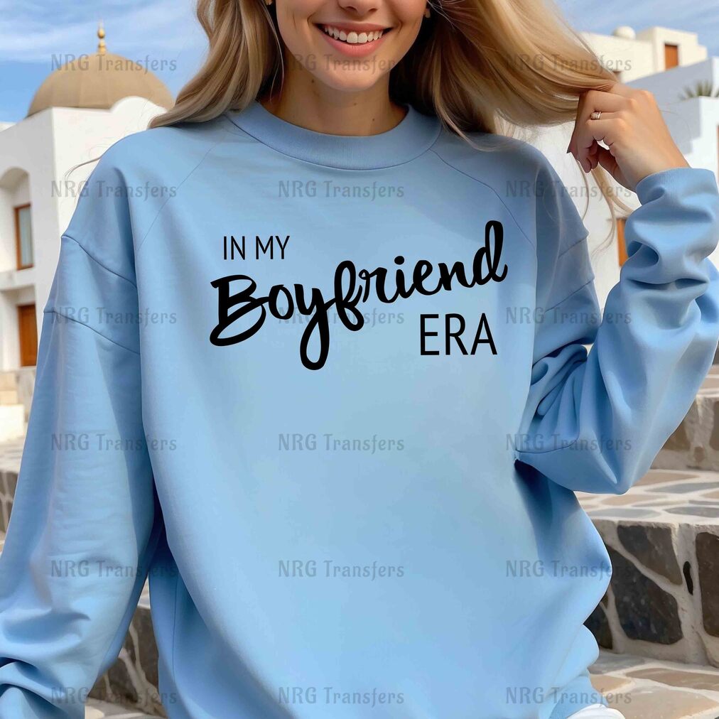 a woman wearing a blue sweatshirt that says in my boyfriend era