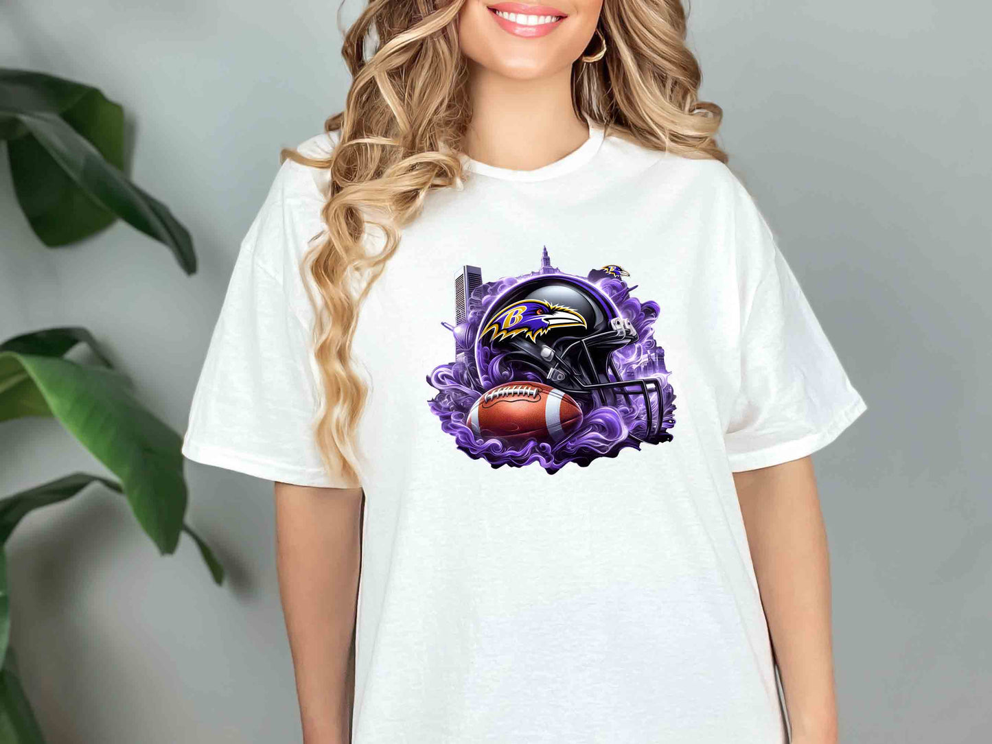 a woman wearing a t - shirt with a football helmet on it