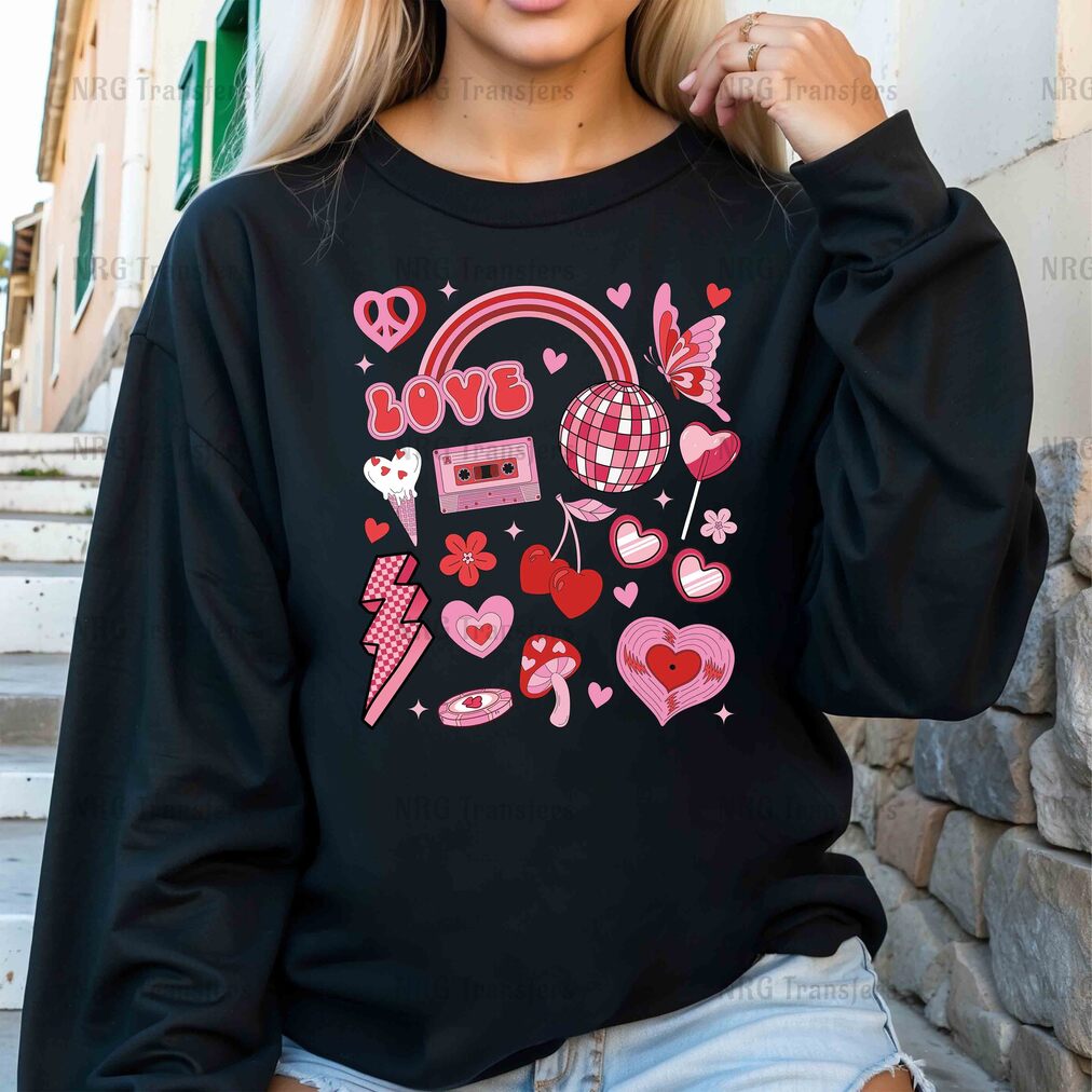 a woman wearing a black sweatshirt with pink hearts and hearts on it