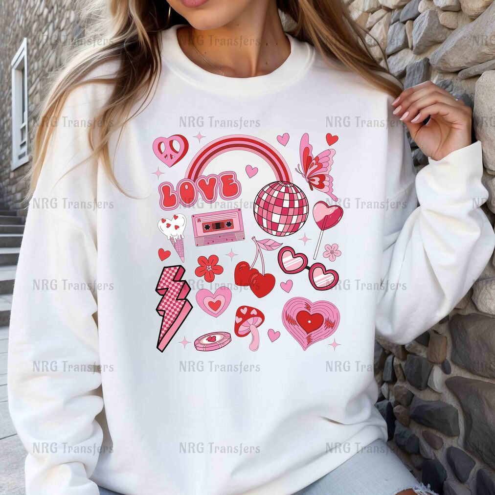 a woman wearing a white sweatshirt with pink hearts and headphones