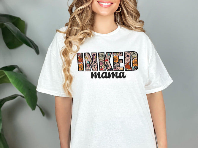 a woman wearing a white t - shirt that says inked mama