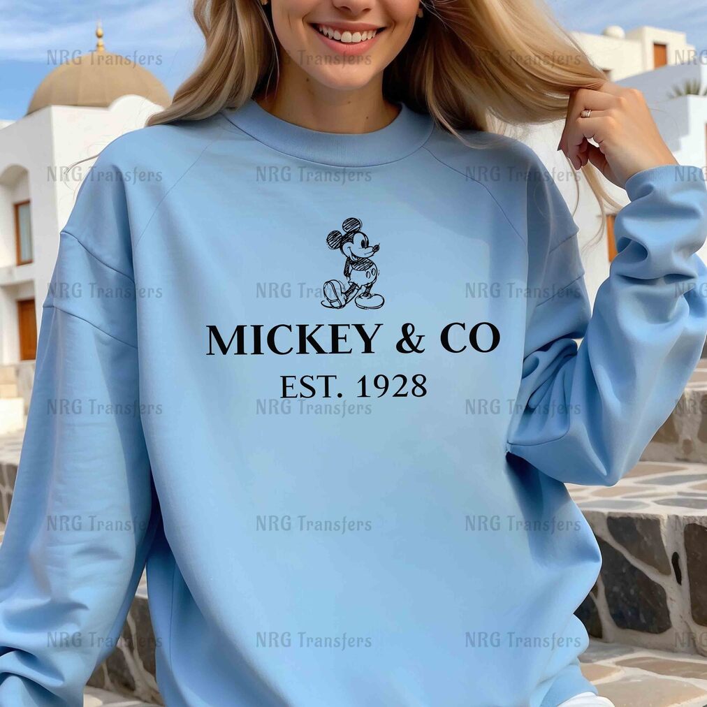 a woman wearing a mickey and co sweatshirt