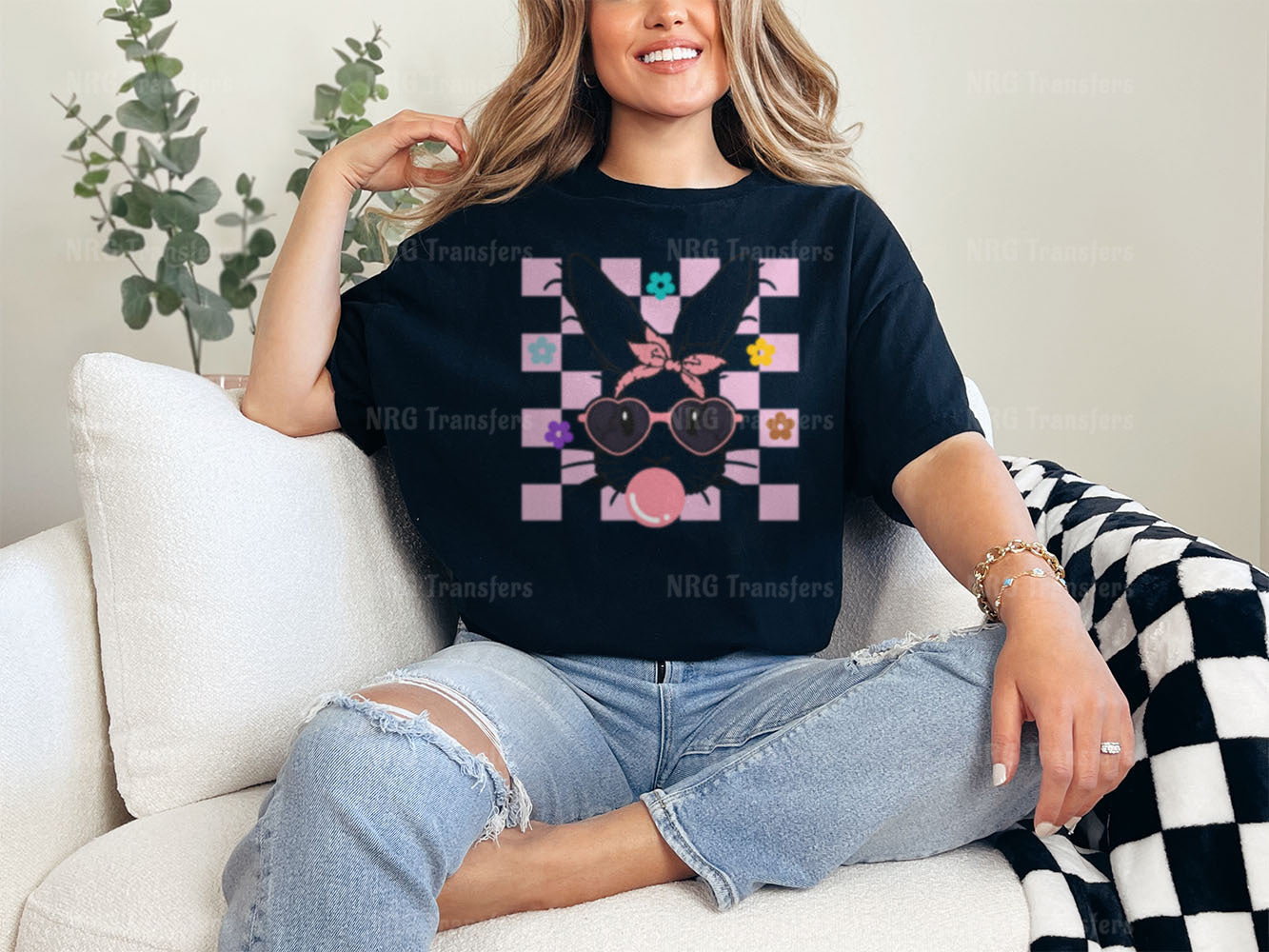 a woman sitting on a couch wearing a t - shirt