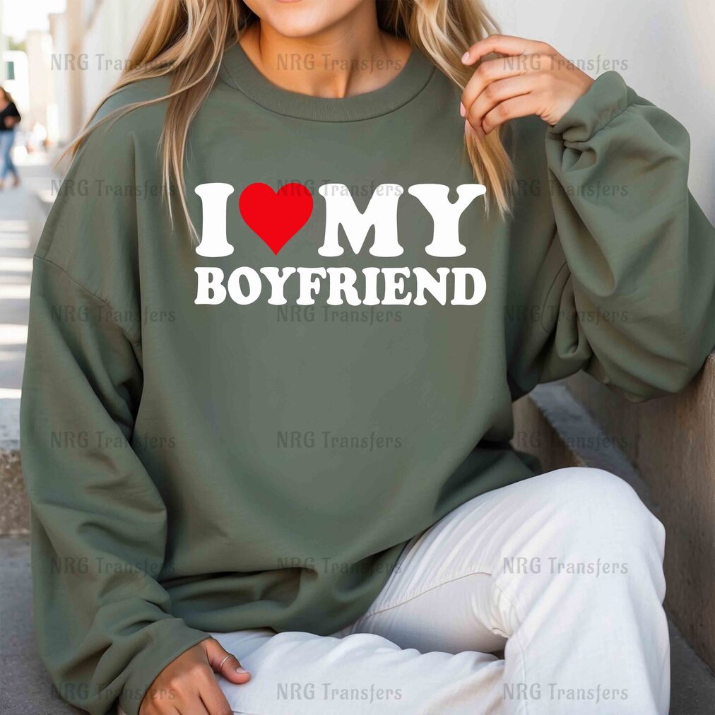 a woman wearing a sweatshirt that says i love my boyfriend