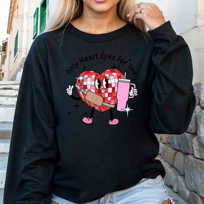 a woman wearing a black sweatshirt with a heart on it