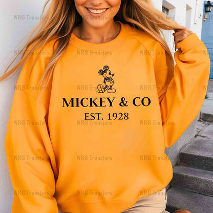 a woman wearing a mickey and co sweatshirt